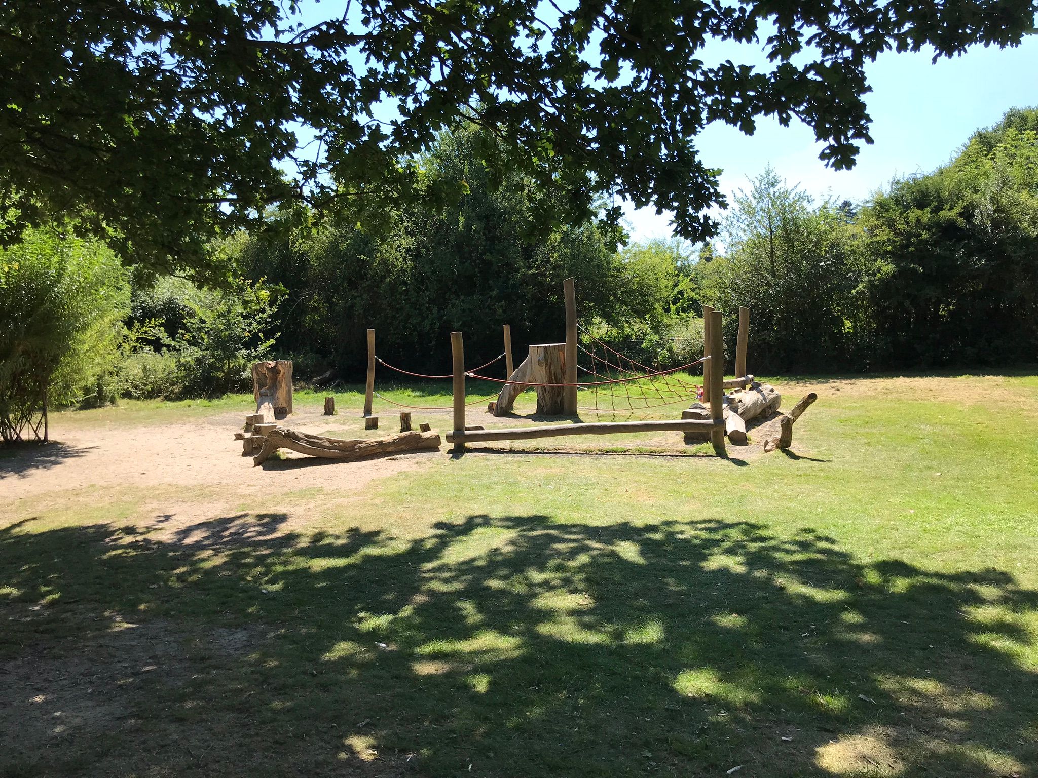 Children's natural play equipment, a series of rope and wooden climbing structures.