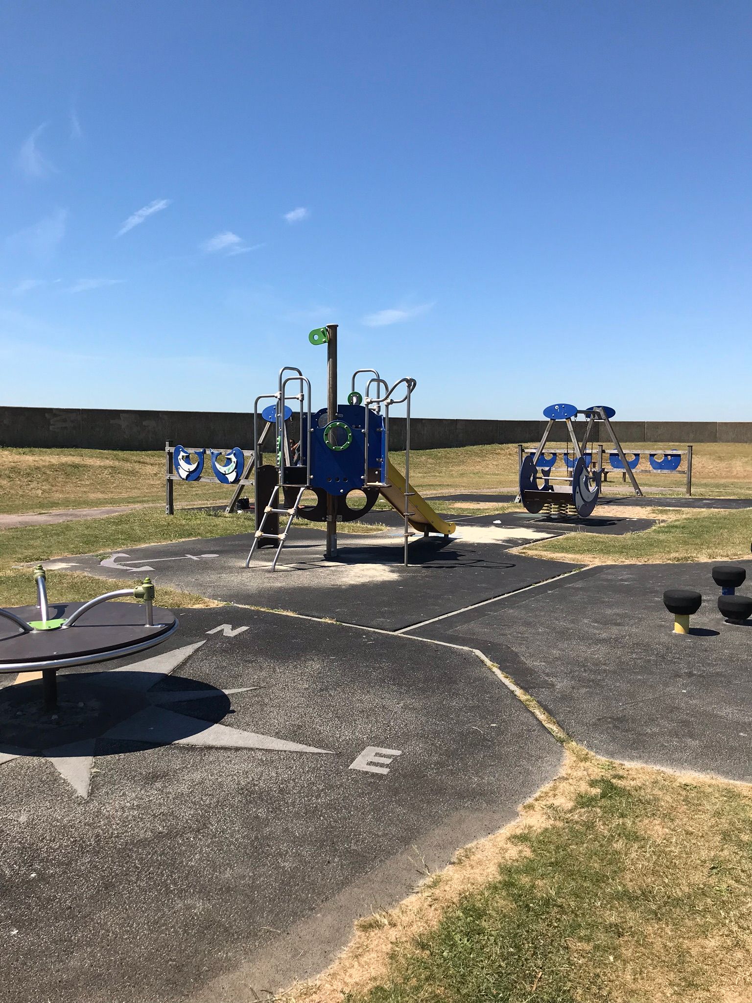 Hampton play area showing teh swings, climbing frame and roundabout