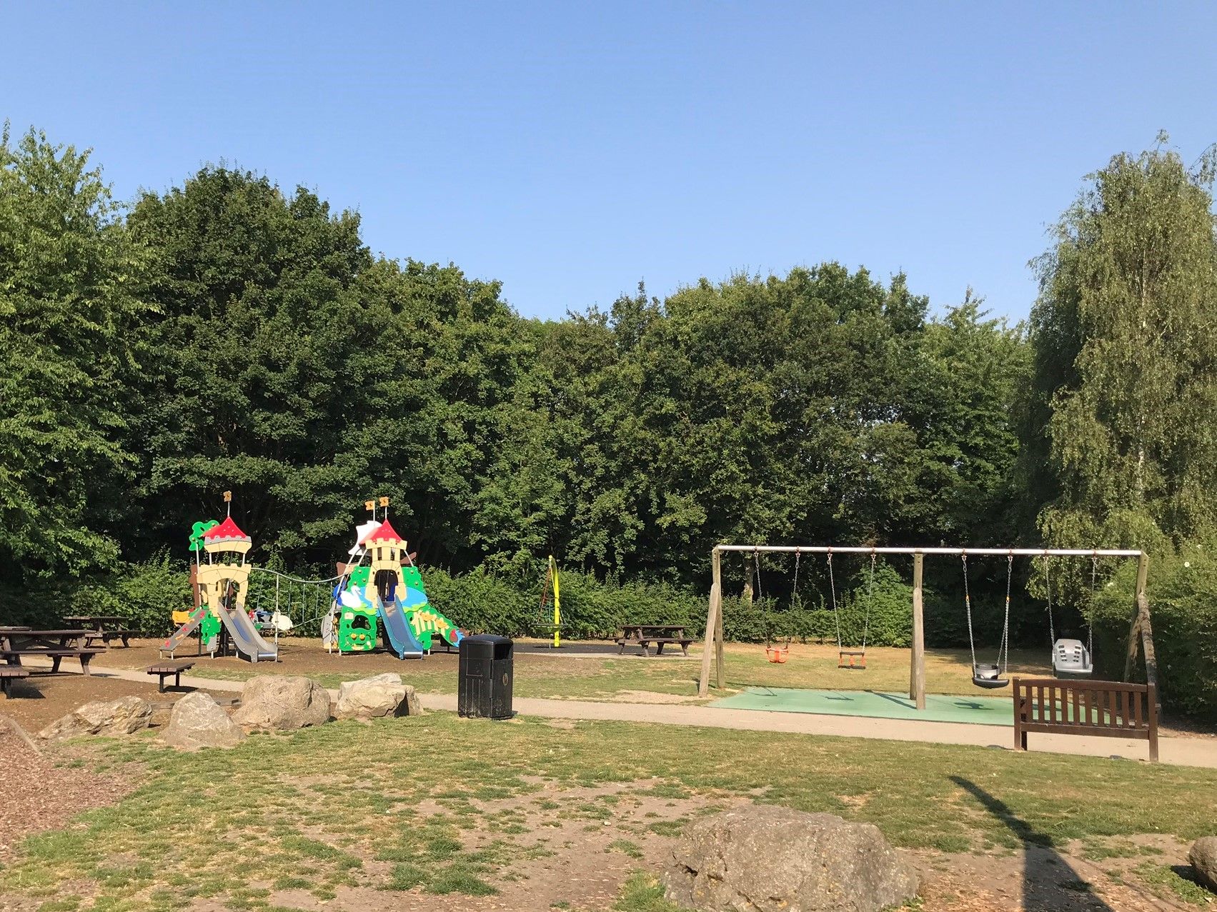 View of the children's Nursery Rhyme themed climbing frame and accessible swings at Riverside Country Park