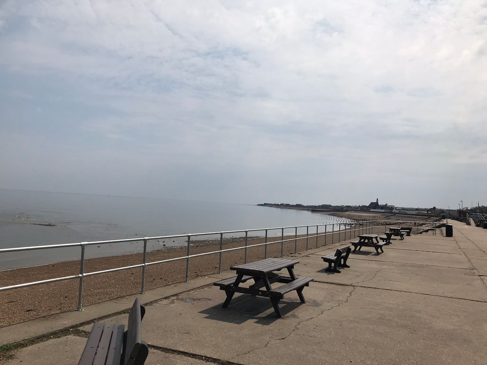 Picnic benches and tables aong the sea wall