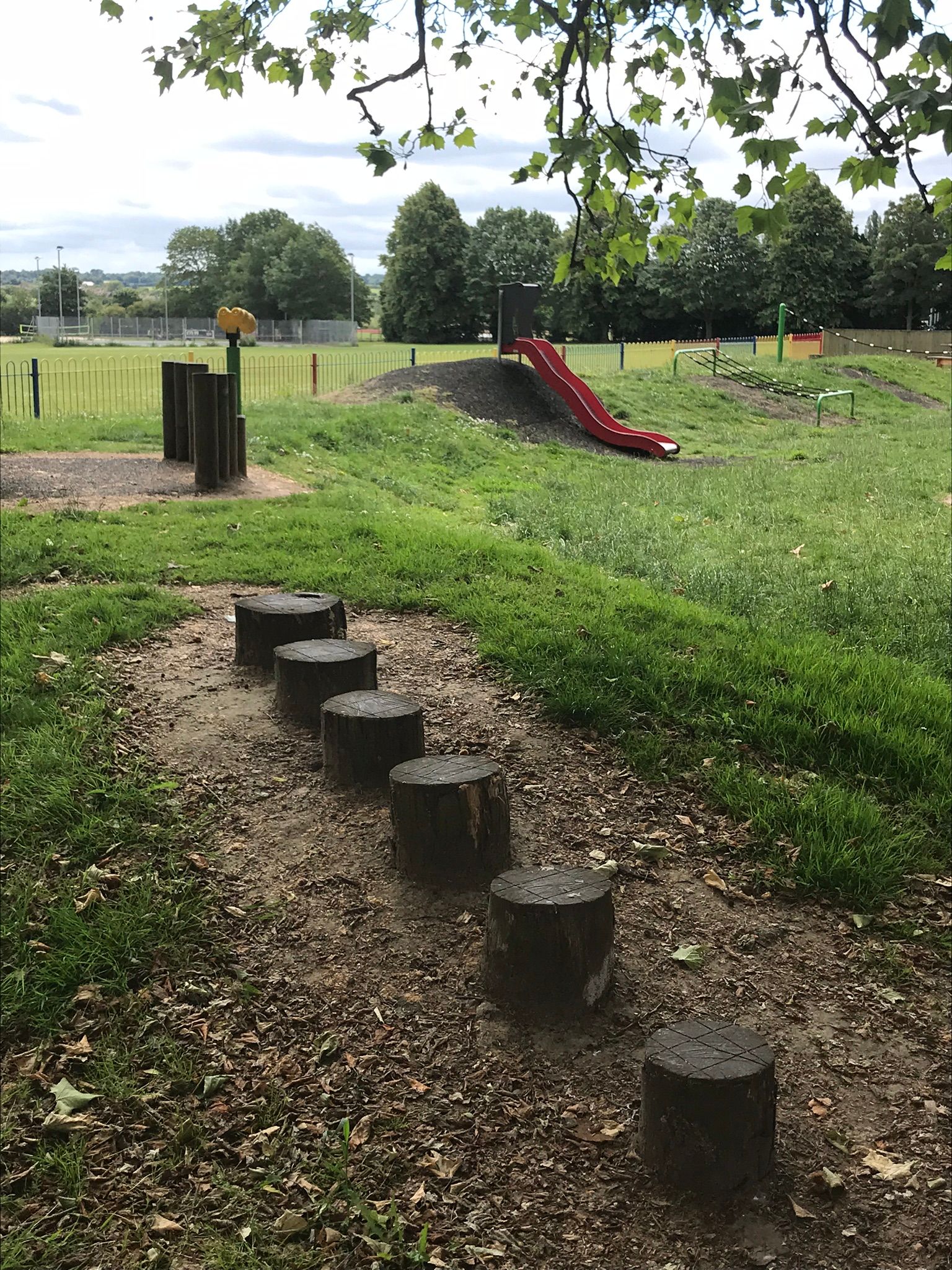 stepping stones, look out and play equipment set into the grassy bank