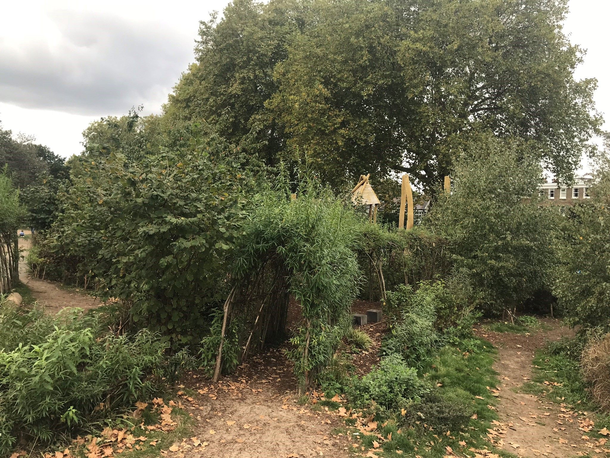 Willow tunnels and play equipment in the play area at Greenwich Park